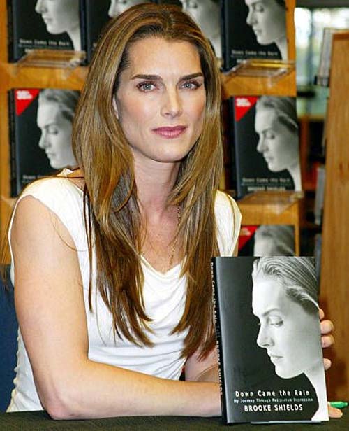 Brooke posing for a picture with her book.